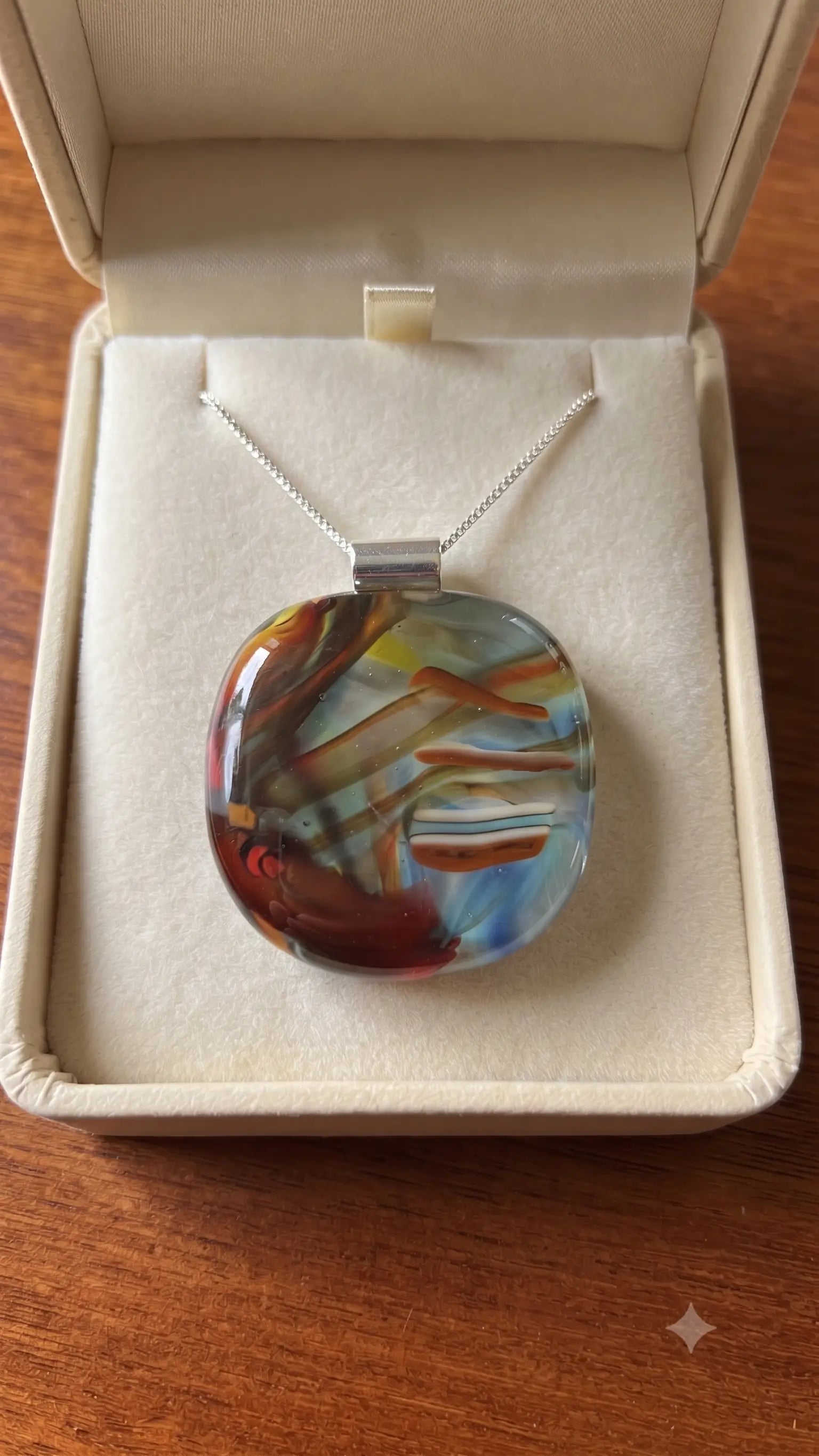 Brushstroke fused glass pendant presented in a Stoney Lake Glassworks gift box