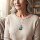 Model wearing the Meadow Mist sage green fused glass pendant on a silver chain