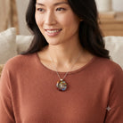 Model wearing the Brushstroke red and blue fused glass pendant on a silver chain