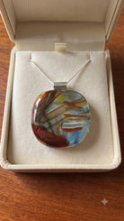 Brushstroke fused glass pendant presented in a Stoney Lake Glassworks gift box